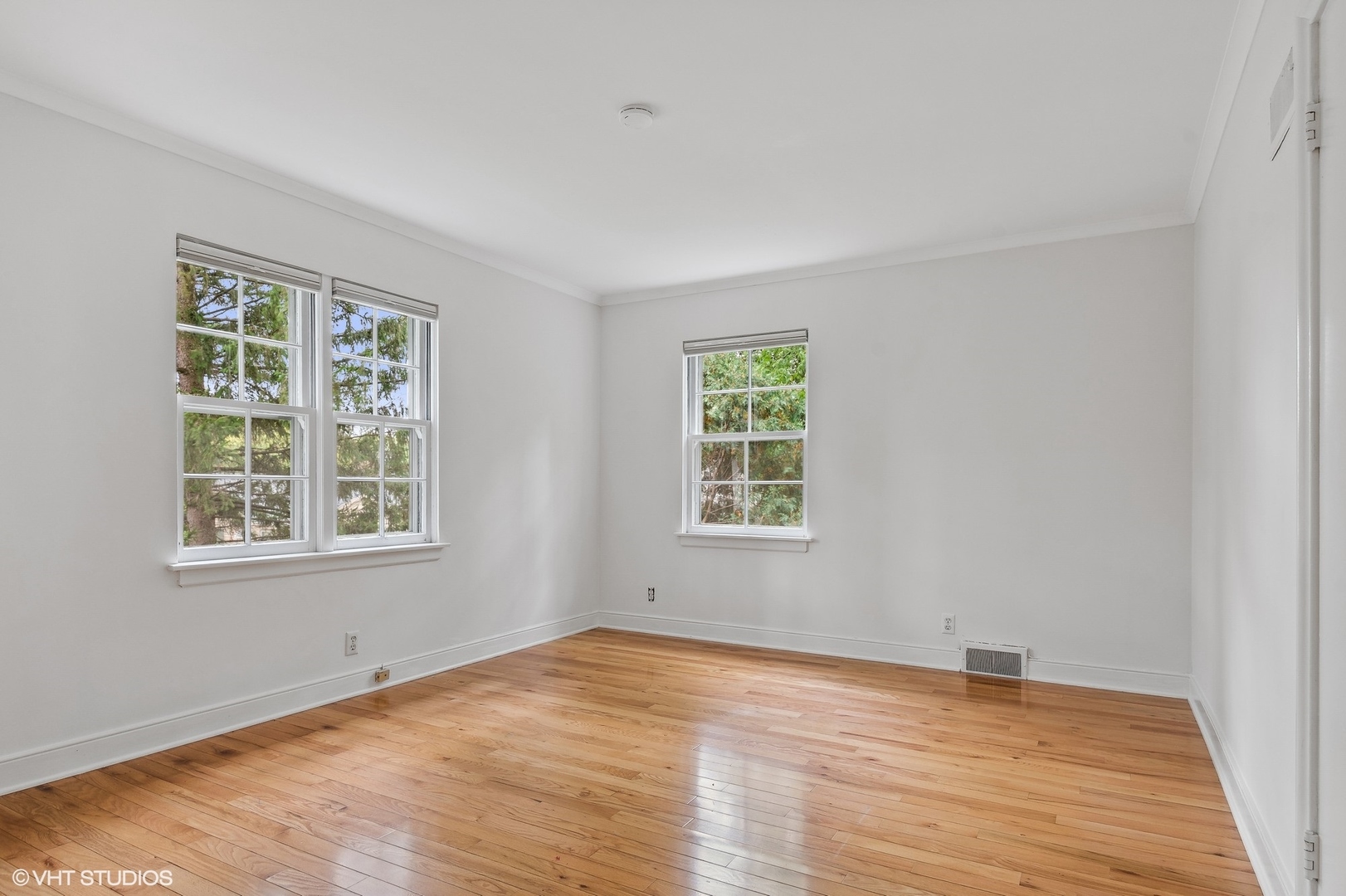 915 Pawnee Road Wilmette, IL 60091 - Photo 22 of 39 an empty room with wooden floor and windows
