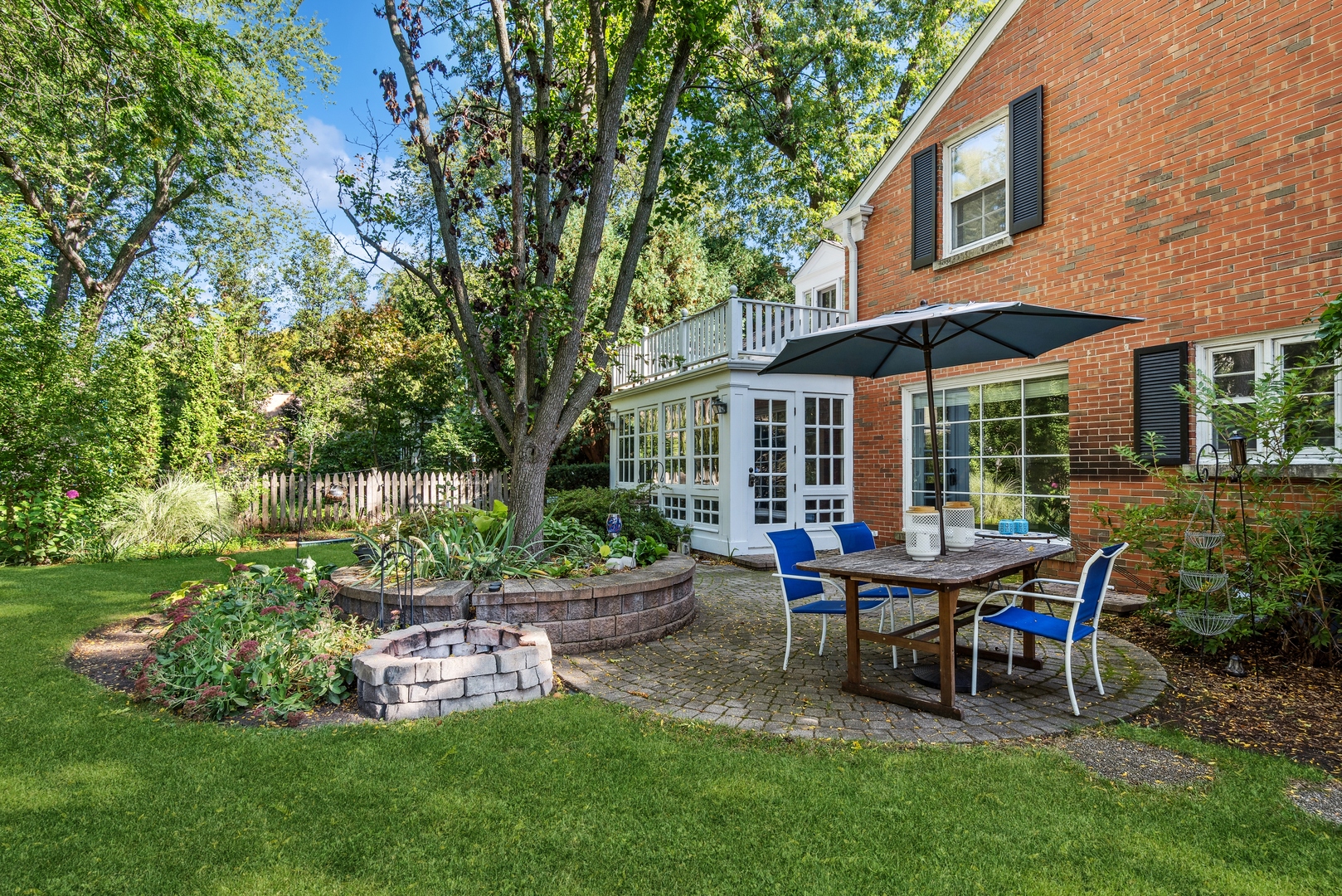 915 Pawnee Road Wilmette, IL 60091 - Photo 26 of 39 a view of a house with backyard sitting area and garden