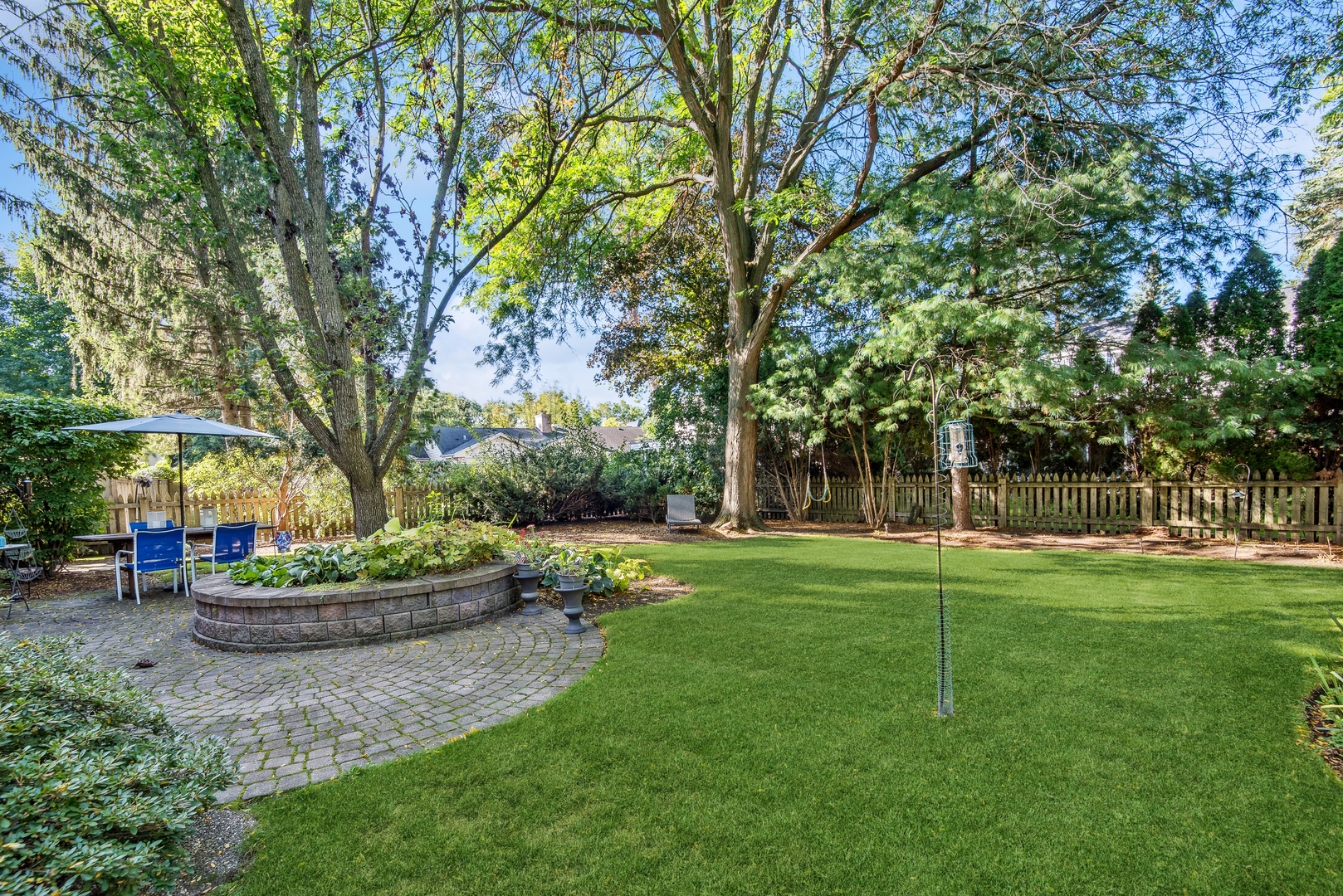 915 Pawnee Road Wilmette, IL 60091 - Photo 28 of 39 a backyard of a house with lots of green space and fountain