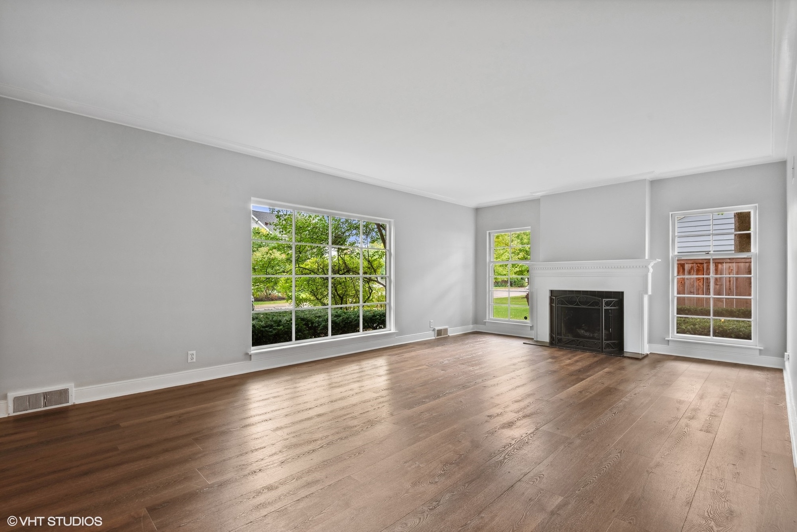 915 Pawnee Road Wilmette, IL 60091 - Photo 3 of 39 a view of a room with wooden floor fireplace and windows