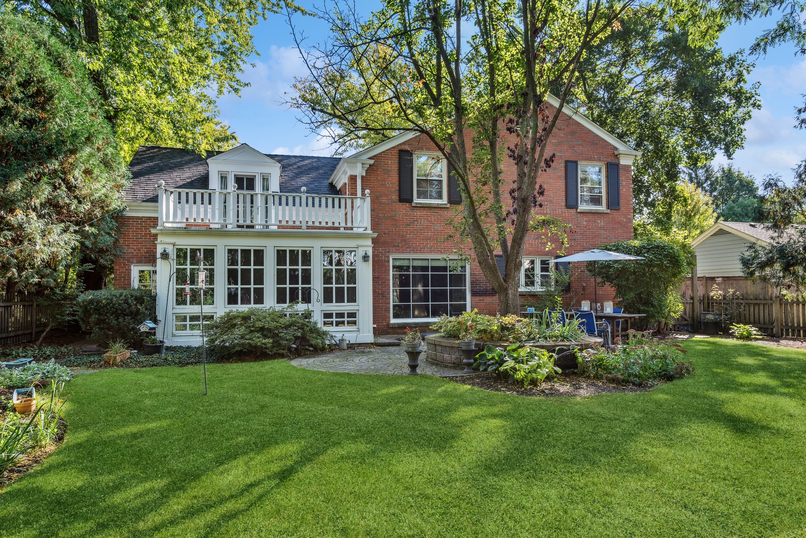 915 Pawnee Road Wilmette, IL 60091 - Photo 31 of 39 a front view of a house with a yard and porch