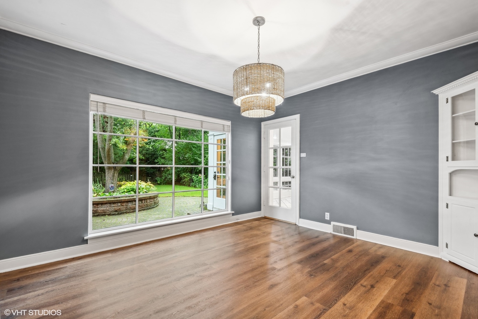 915 Pawnee Road Wilmette, IL 60091 - Photo 4 of 39 a view of an empty room with wooden floor and a window