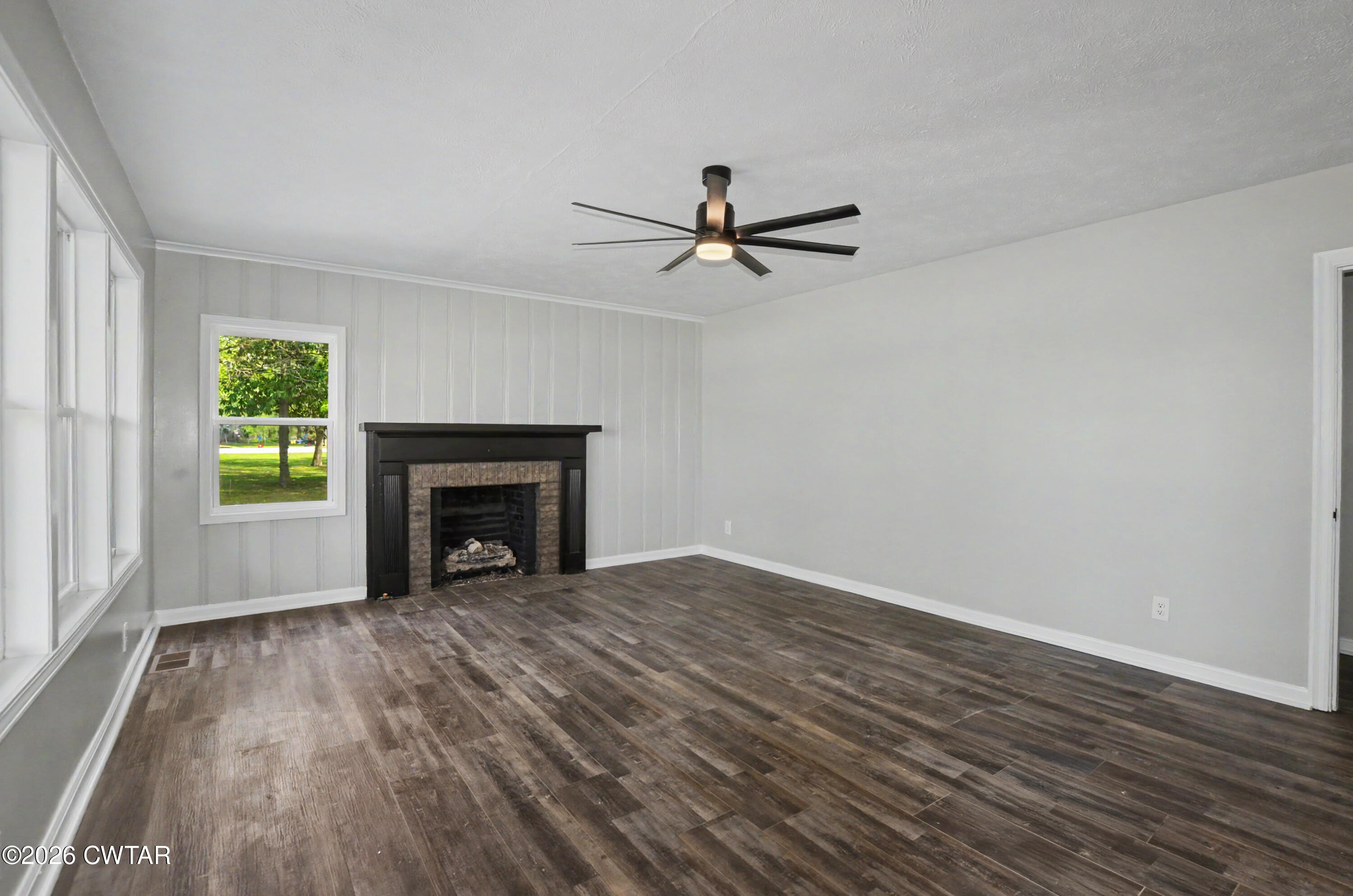 4177 Gum Flat Road Bells, TN 38006 - Photo 14 of 30 wooden floor fireplace and windows in an empty room