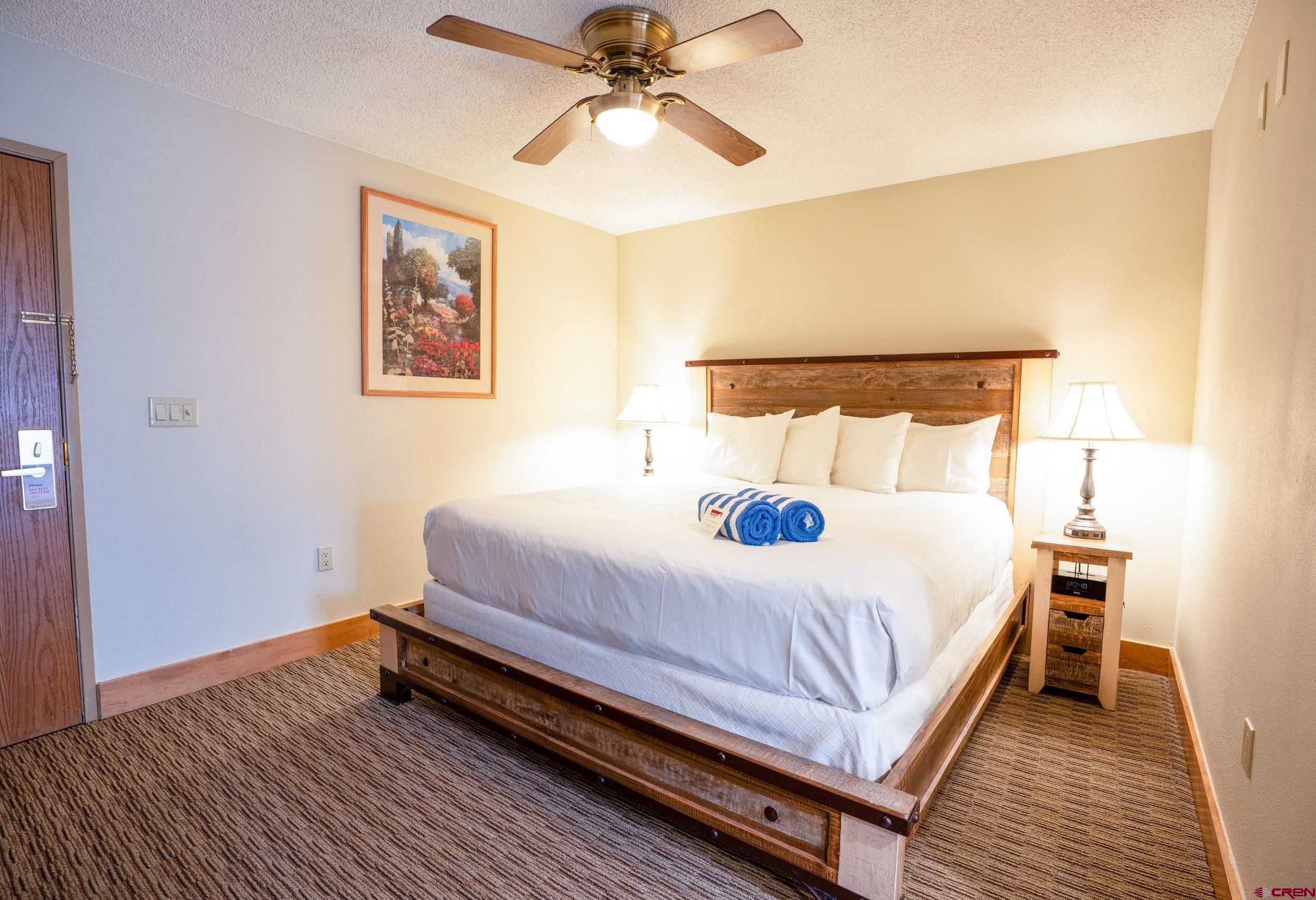 6 Emmons Road, Unit 463 Crested Butte, CO 81225 - Photo 11 of 21 a bedroom with a bed and a chandelier