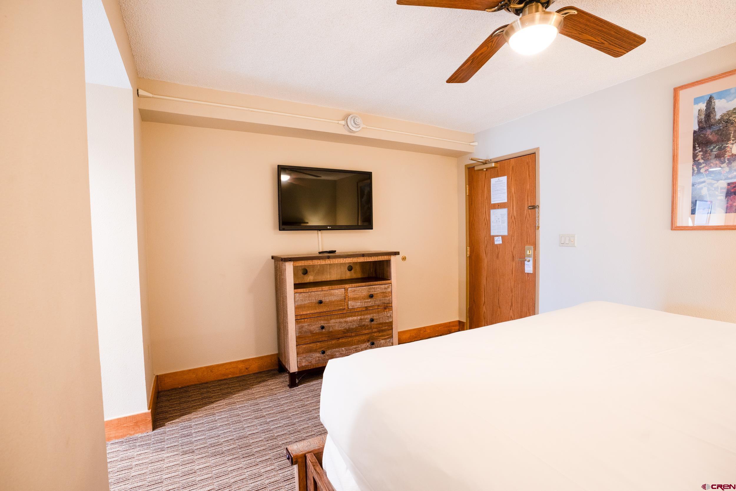 6 Emmons Road, Unit 463 Crested Butte, CO 81225 - Photo 12 of 21 a bedroom with a bed and a flat screen tv