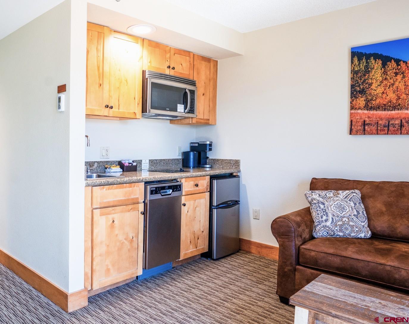 6 Emmons Road, Unit 463 Crested Butte, CO 81225 - Photo 5 of 21 a living room with stainless steel appliances granite countertop furniture wooden floor and a window