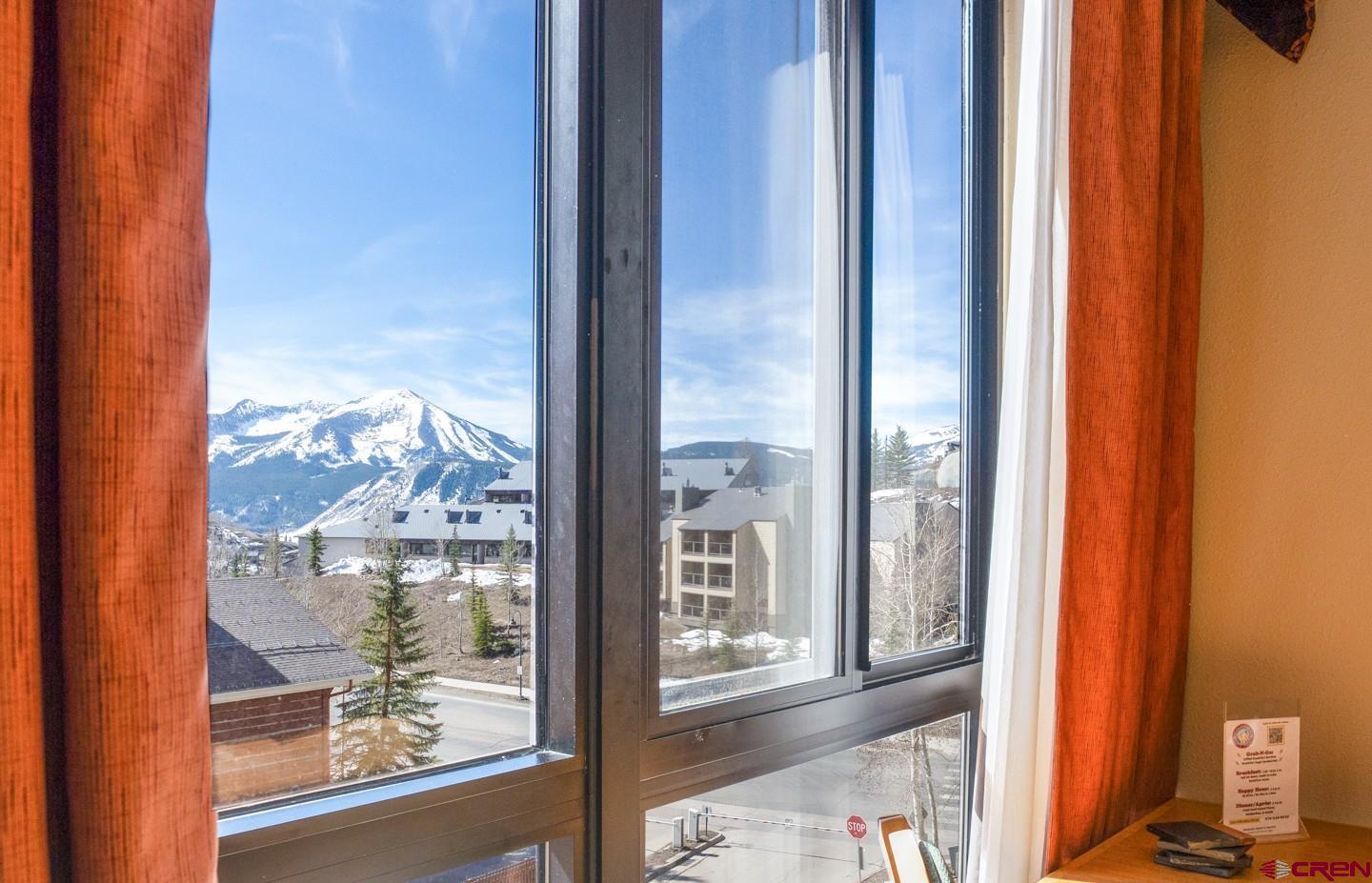 6 Emmons Road, Unit 463 Crested Butte, CO 81225 - Photo 7 of 21 a view of a room with a large window and a bed