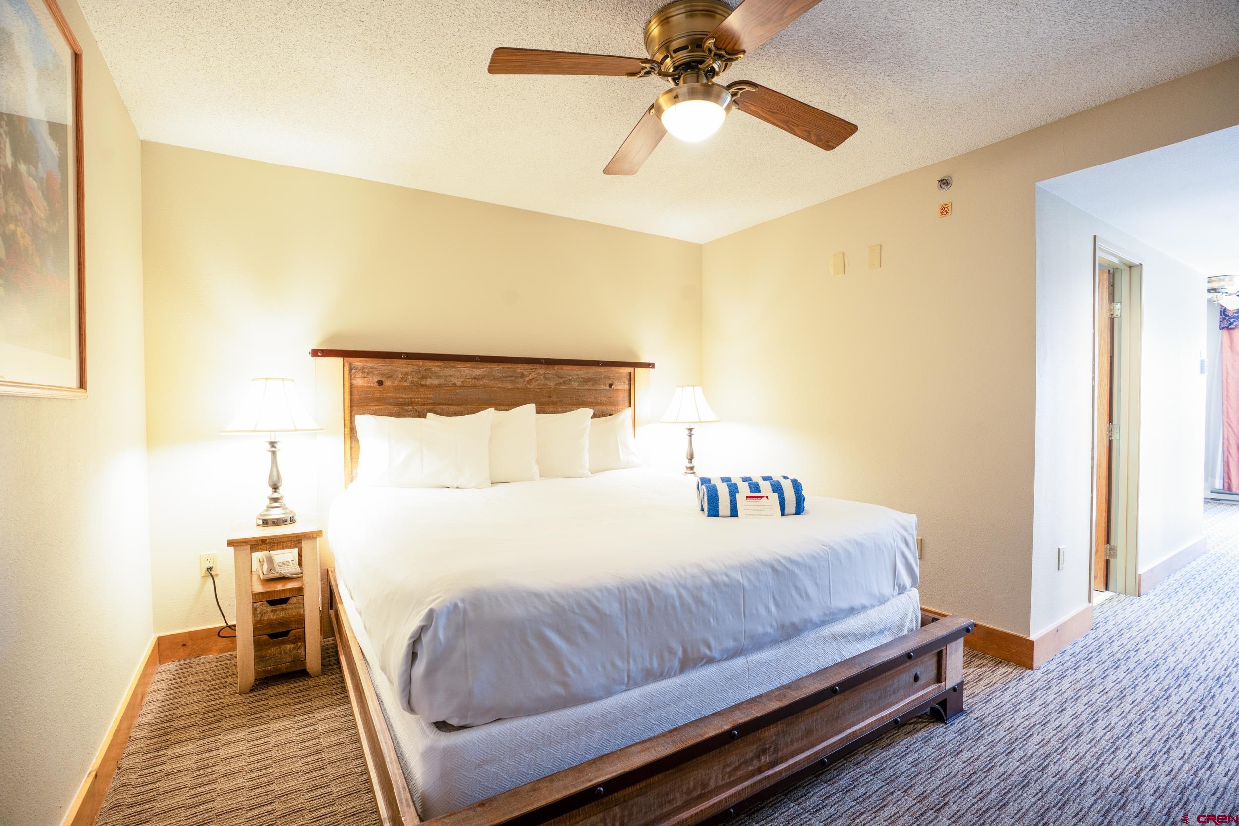 6 Emmons Road, Unit 463 Crested Butte, CO 81225 - Photo 10 of 21 a bedroom with a bed and wooden floor