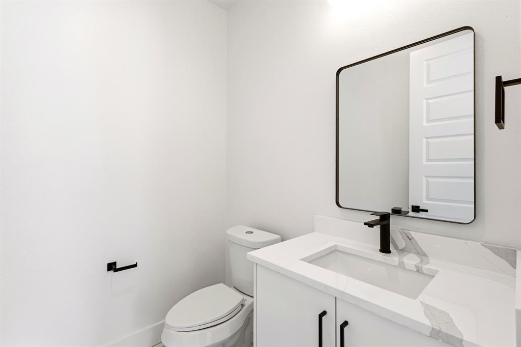 413 North Patton Avenue Dallas, TX 75203 - Photo 8 of 21 a bathroom with a sink a toilet and mirror