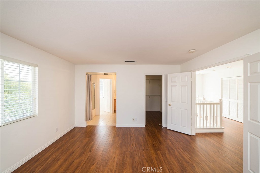 124 Cherrybrook Lane Irvine, CA 92618 - Photo 23 of 28 an empty room with wooden floor and windows