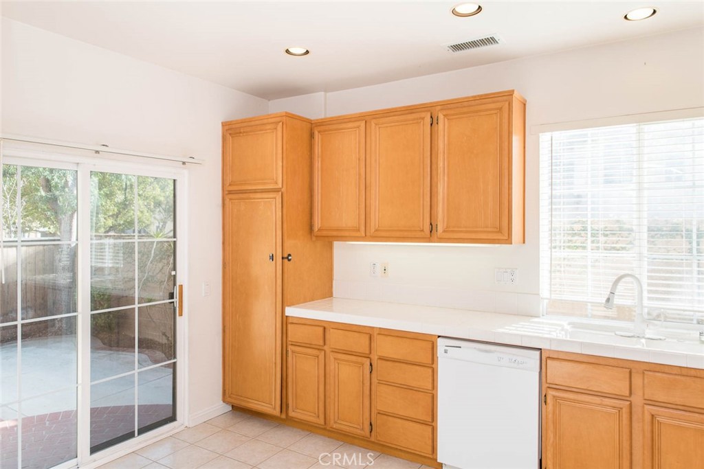 124 Cherrybrook Lane Irvine, CA 92618 - Photo 3 of 28 a kitchen with granite countertop a sink and a window