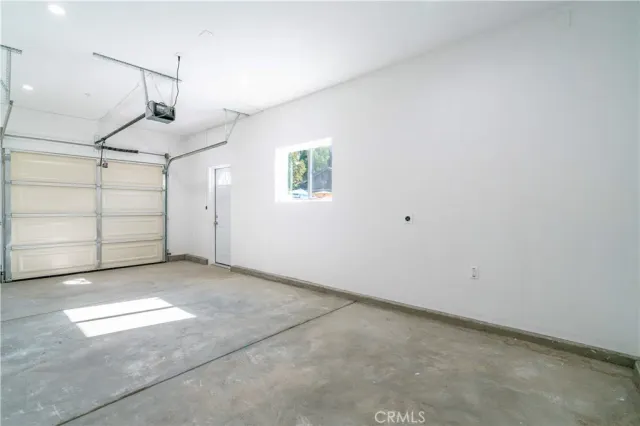 a view of a chair and table in backyard of the house