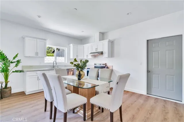 a kitchen with stainless steel appliances granite countertop a sink a window and cabinets