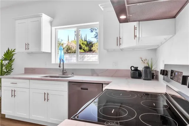 a kitchen with a sink stove and cabinets