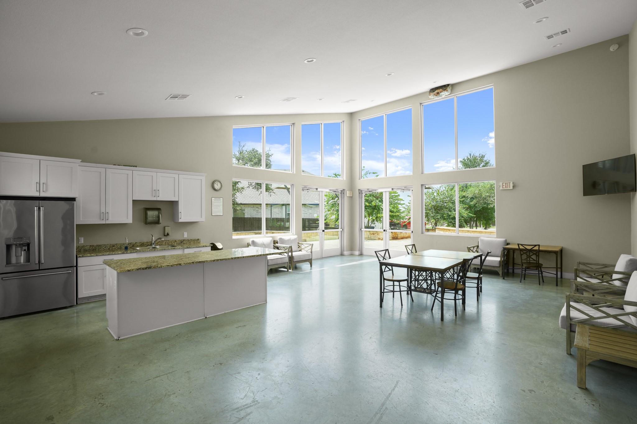 152 Mountain Valley Street Georgetown, TX 78628 - Photo 34 of 38 Polished concrete floors and soaring windows define this light-filled clubhouse space with kitchen facilities.