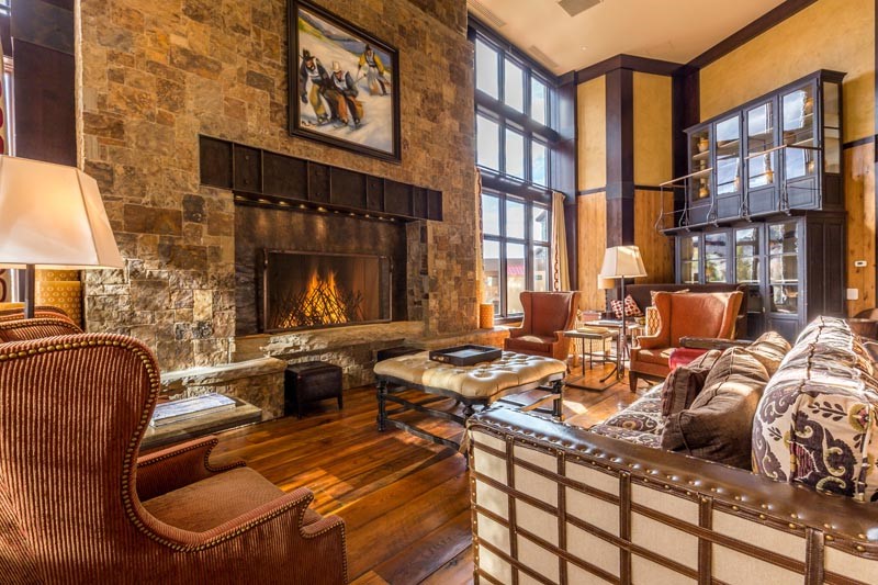 34905 Rockledge Road Steamboat Springs, CO 80487 - Photo 21 of 25 a living room with furniture a fireplace and lots of windows