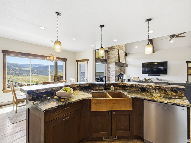 402 Shadow Hill Road Wanship, UT 84017 - Photo 90 of 90 Kitchen featuring a mountain view, dark wood finish cabinetry, stainless steel dishwasher, open floor plan, and hanging light fixtures