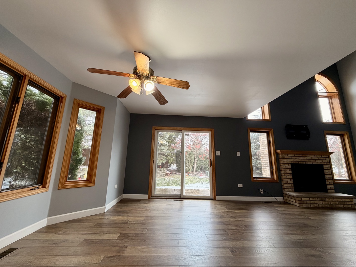 19301 Enclave Lane Tinley Park, IL 60487 - Photo 4 of 18 an empty room with wooden floor and windows