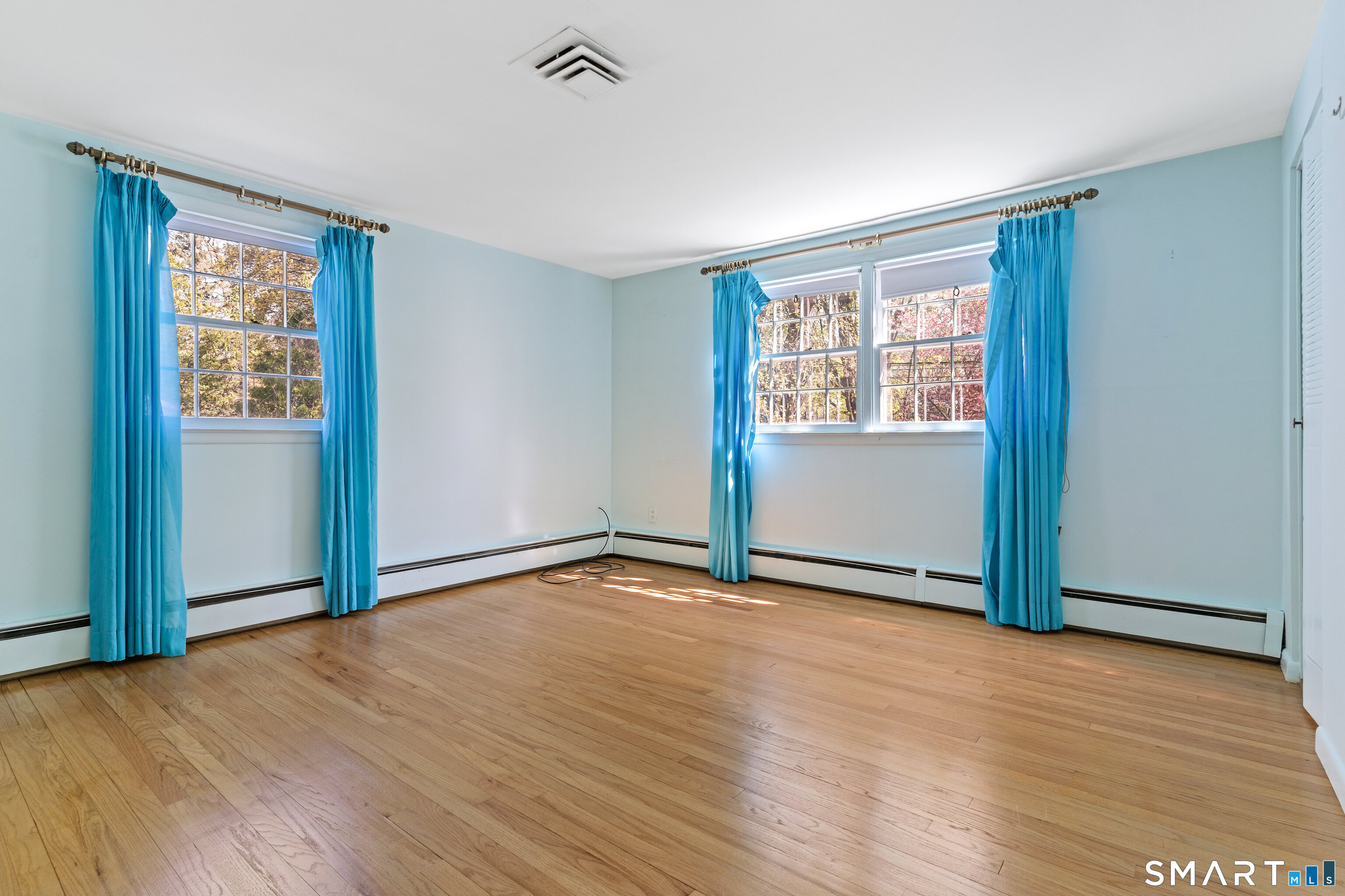 251 Shelter Rock Road Fairfield, CT 06825 - Photo 22 of 38 an empty room with wooden floor and windows