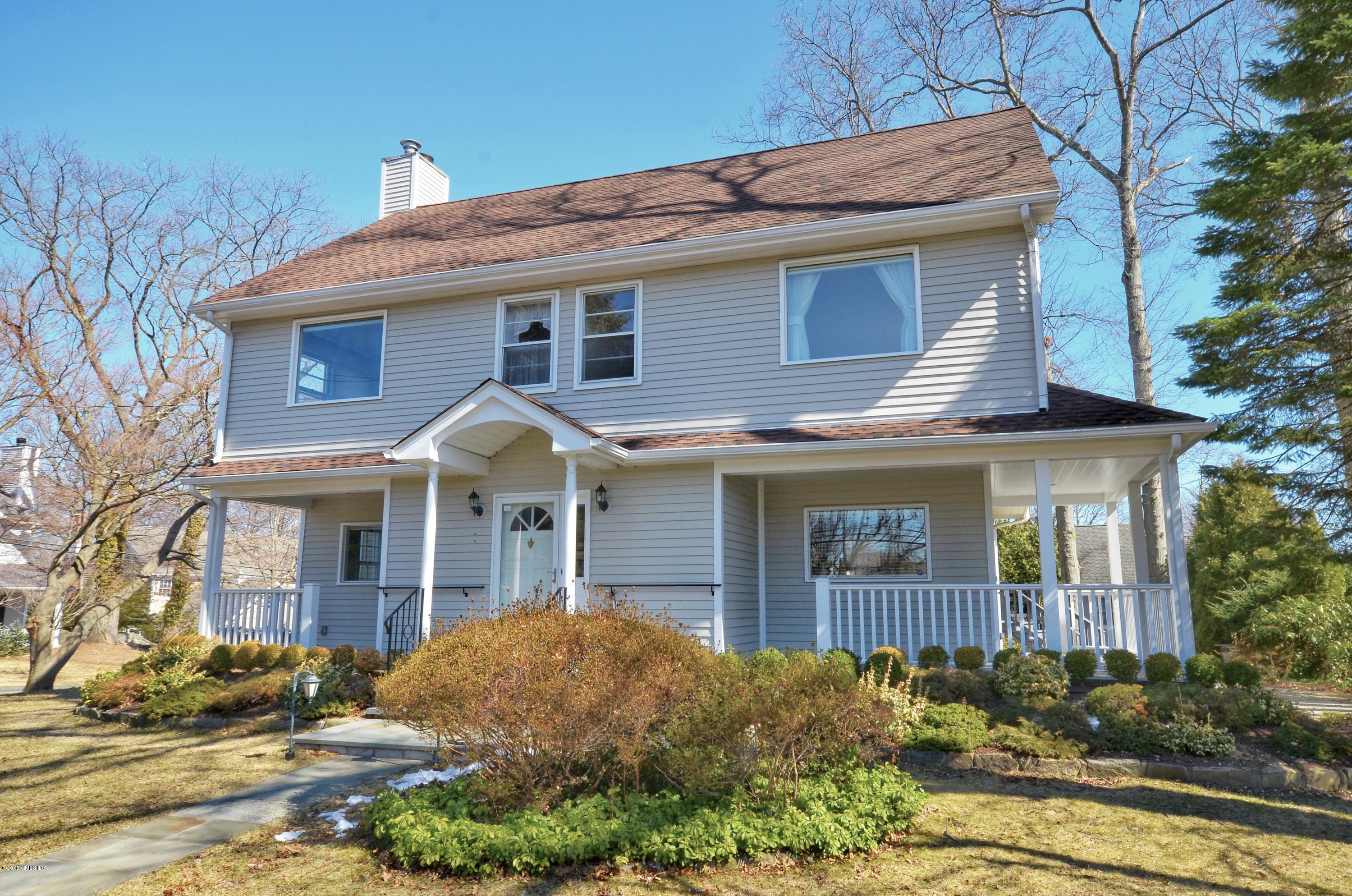 1 Elizabeth Lane Riverside, CT 06878 - Photo 1 of 26 a view of a white house with large windows and a small yard