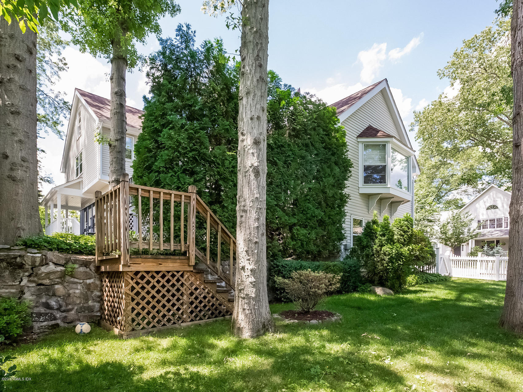 1 Elizabeth Lane Riverside, CT 06878 - Photo 22 of 26 a view of a brick house with a yard and plants