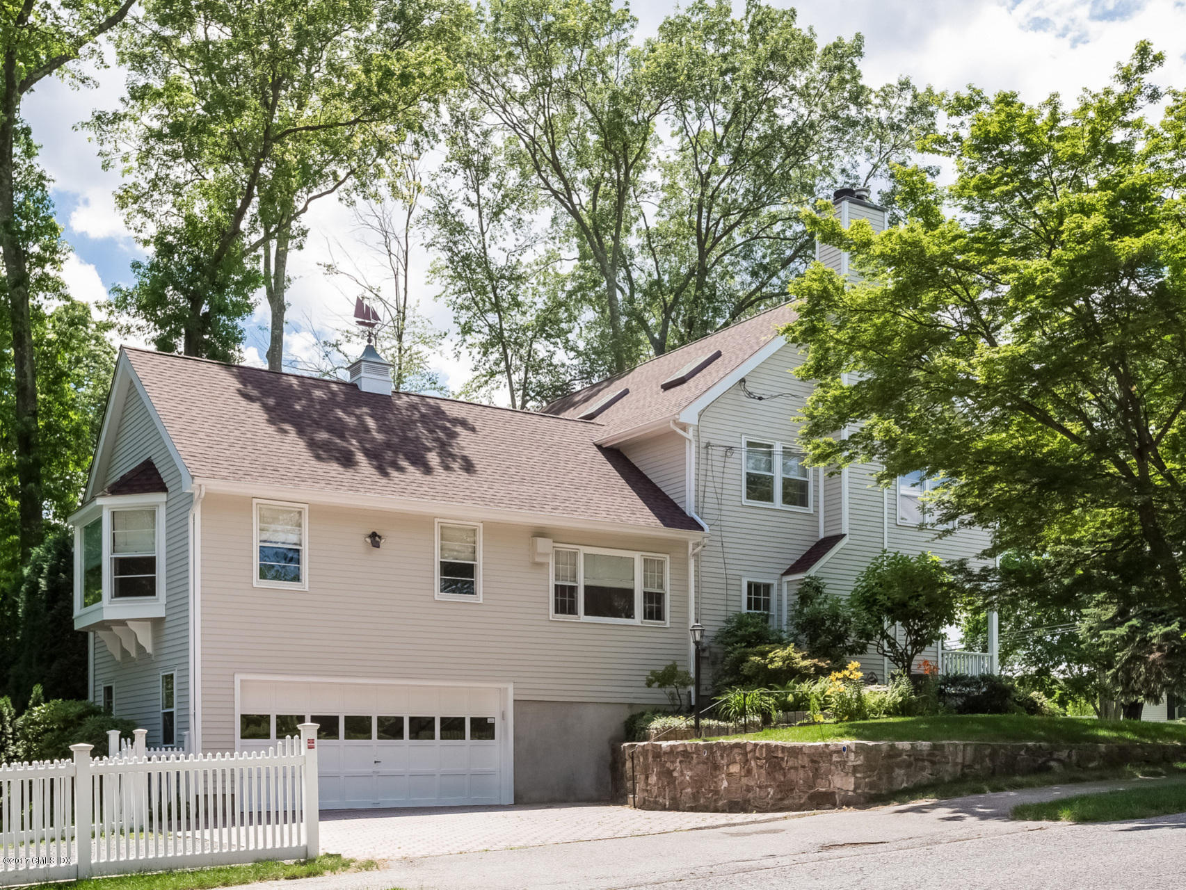 1 Elizabeth Lane Riverside, CT 06878 - Photo 23 of 26 a view of a white house with a small yard and large tree