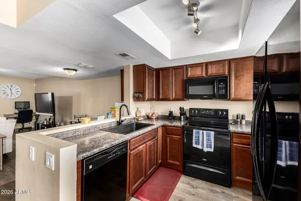 a kitchen with a sink stove and microwave