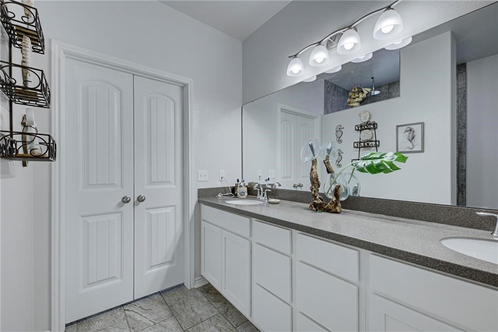 1007 Ocean Breeze Portland, TX 78374 - Photo 11 of 17 a bathroom with a double vanity sink and a mirror