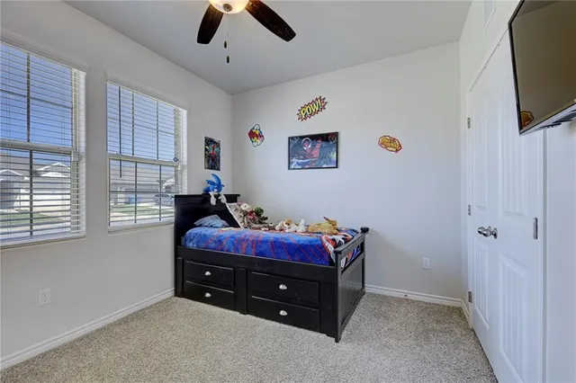 a bedroom with furniture and a flat screen tv