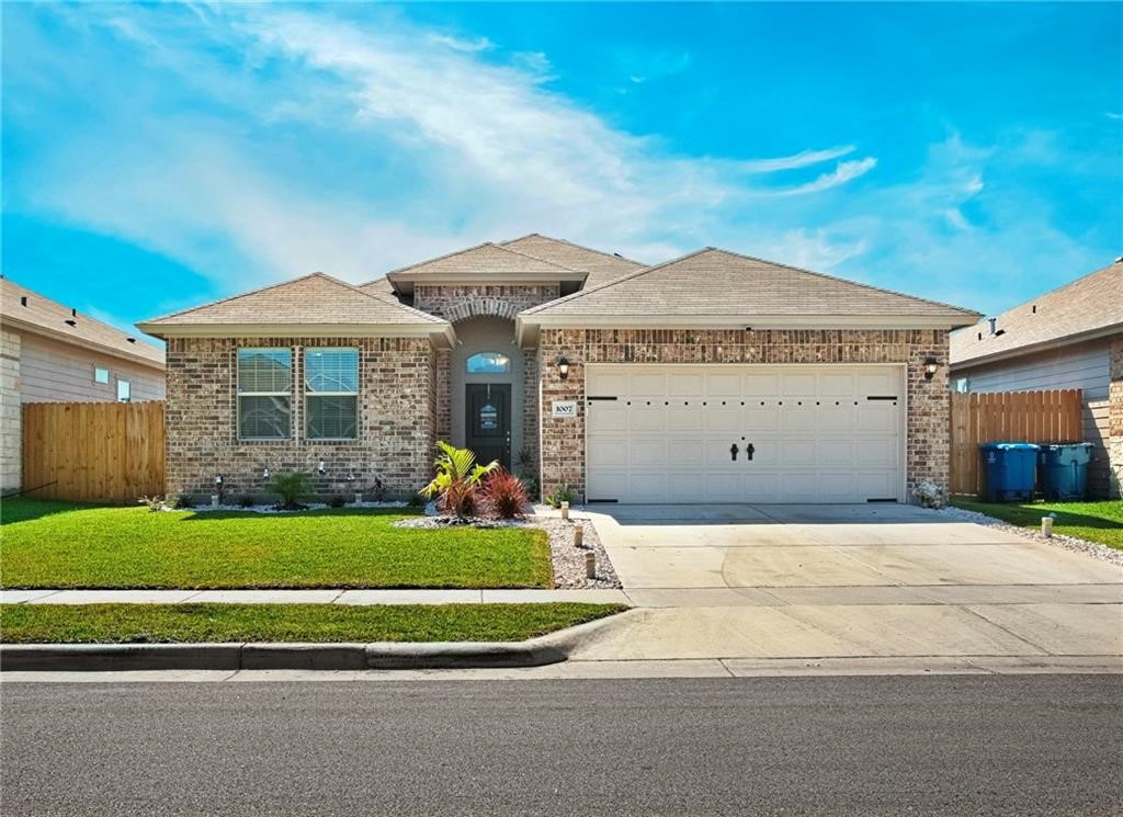 1007 Ocean Breeze Portland, TX 78374 - Photo 2 of 17 a front view of a house with a garden