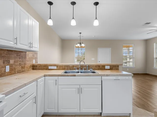 a kitchen that has a sink and cabinets in it