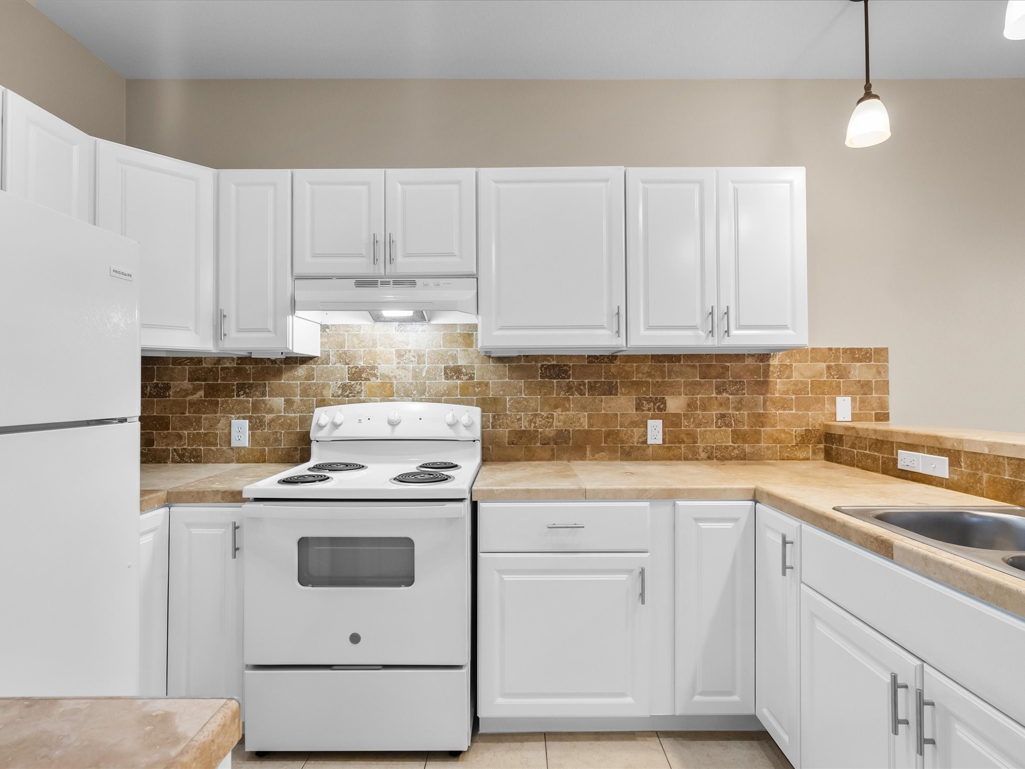 533 12th Street San Leon, TX 77539 - Photo 14 of 29 a kitchen with cabinets appliances a sink and a counter top