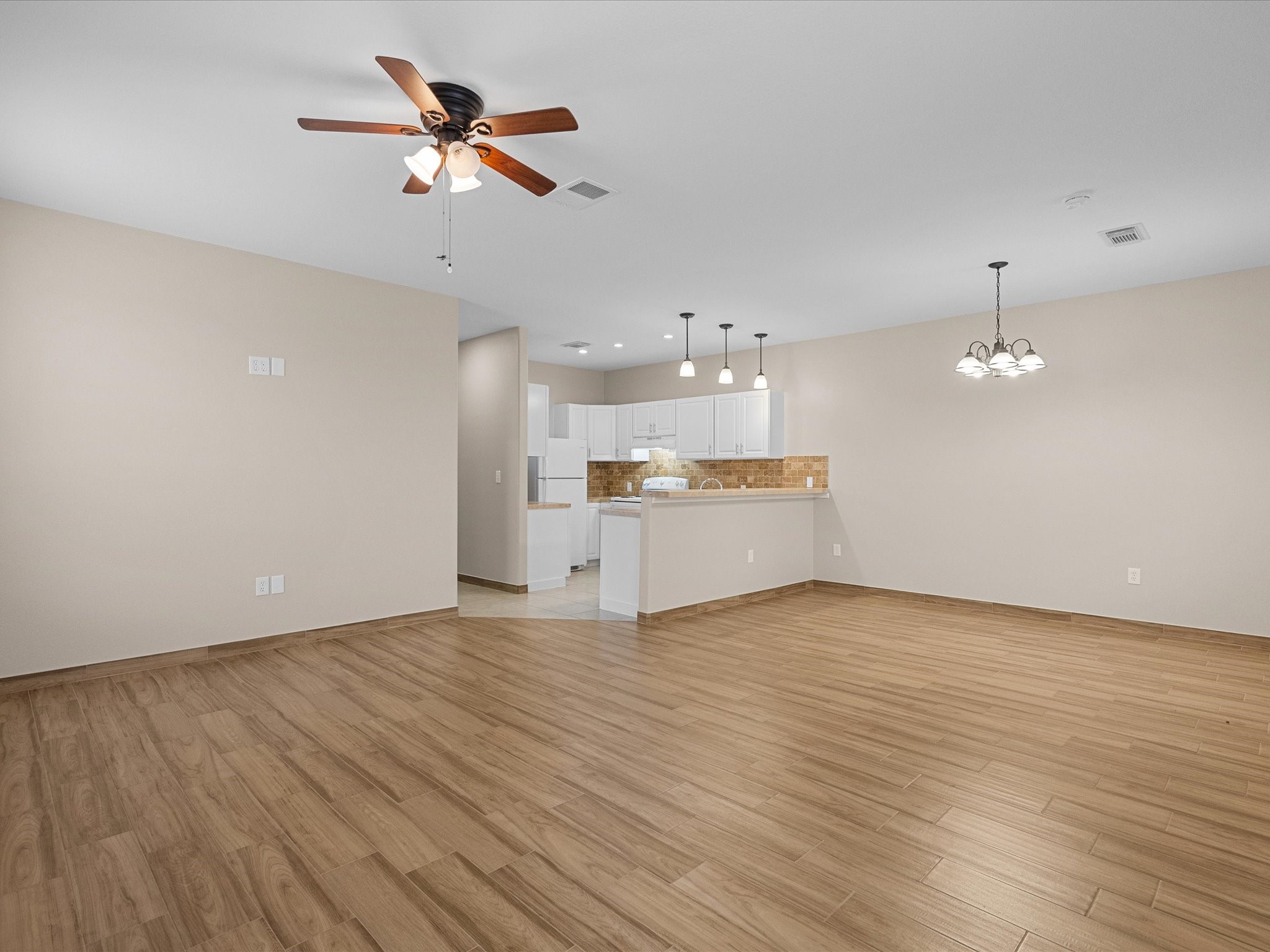533 12th Street San Leon, TX 77539 - Photo 15 of 29 wooden floor in an empty room with a kitchen
