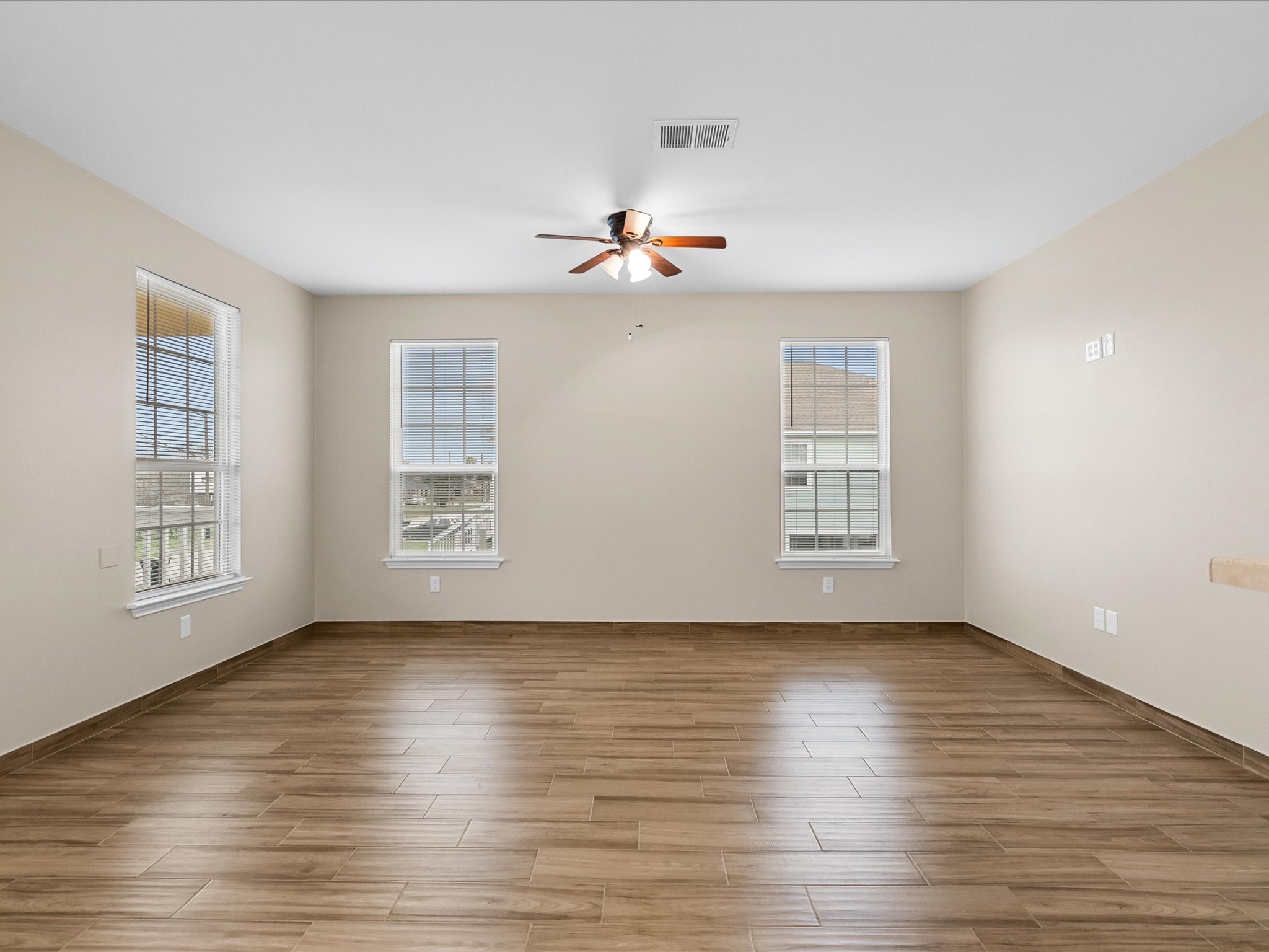 533 12th Street San Leon, TX 77539 - Photo 16 of 29 an empty room with wooden floor chandelier fan and windows