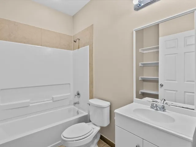 a bathroom with a sink toilet vanity and tub