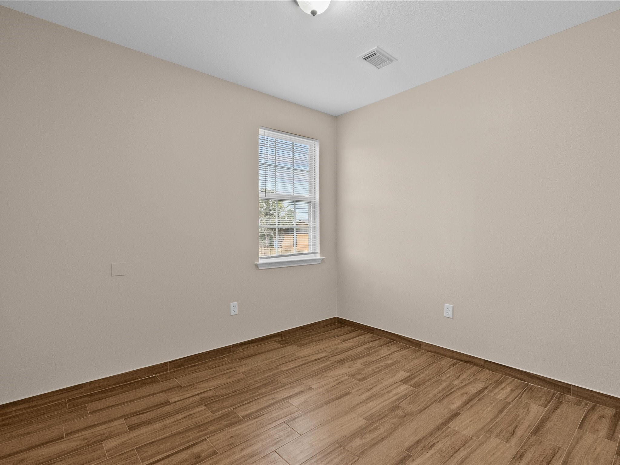 533 12th Street San Leon, TX 77539 - Photo 25 of 29 an empty room with wooden floor and windows