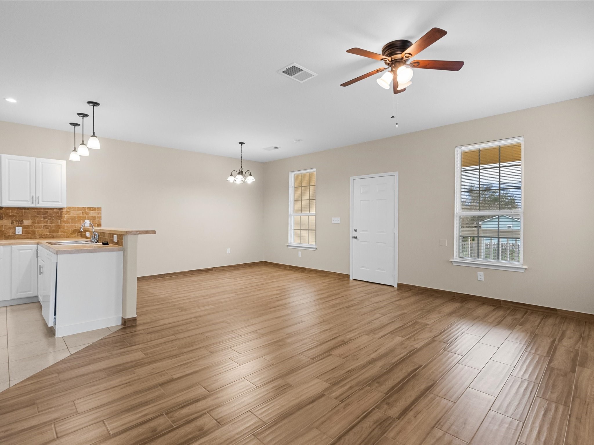 533 12th Street San Leon, TX 77539 - Photo 7 of 29 a view of an empty room with window and wooden floor