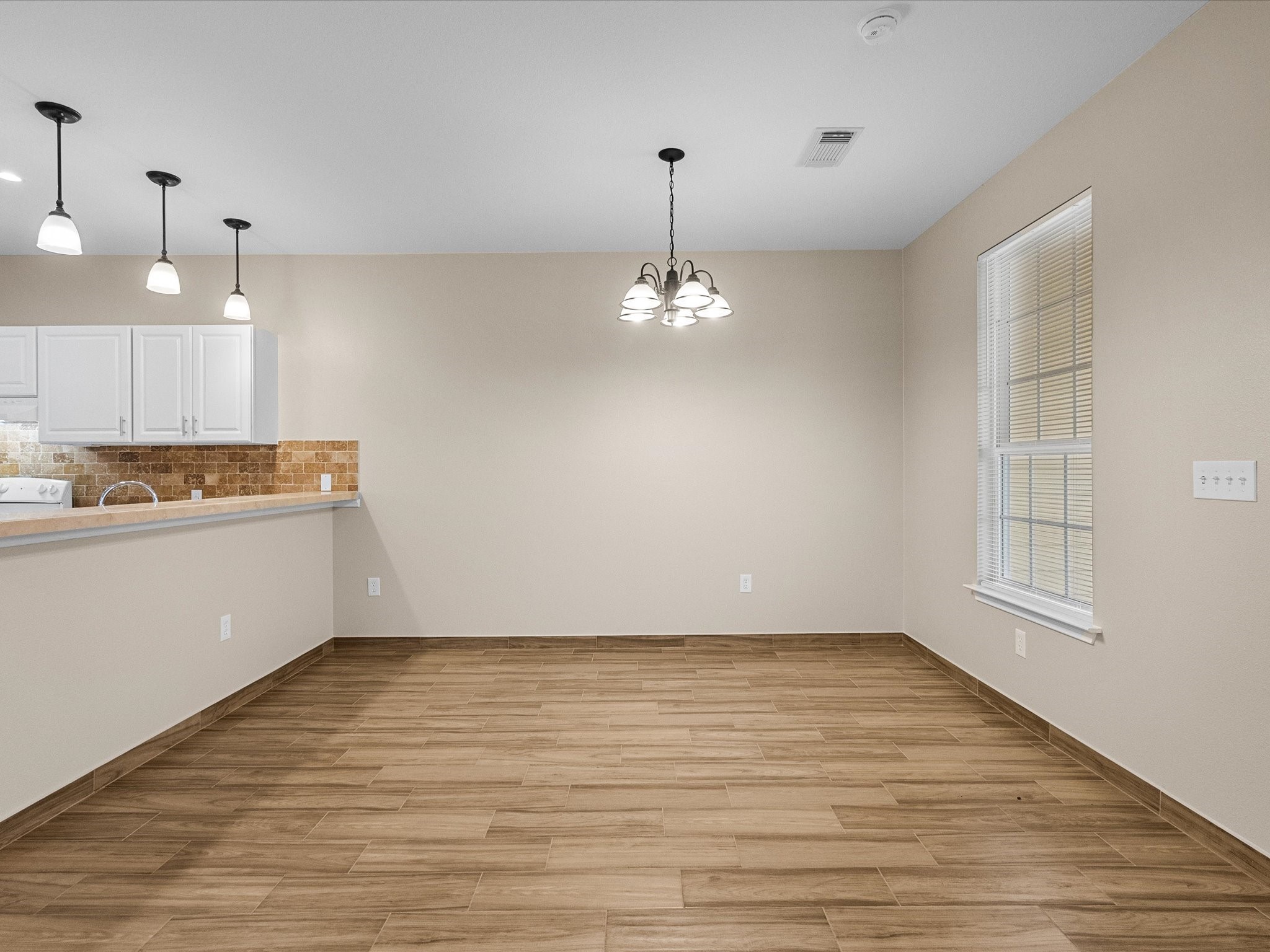 533 12th Street San Leon, TX 77539 - Photo 9 of 29 a view of a room with wooden floor and kitchen