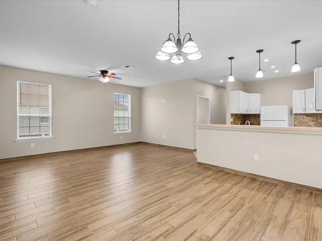 a view of a kitchen with sink and microwave
