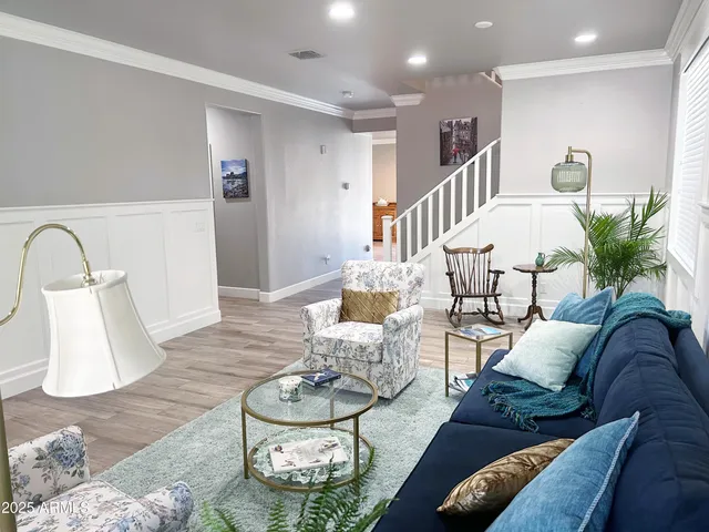 a living room with furniture and a potted plant