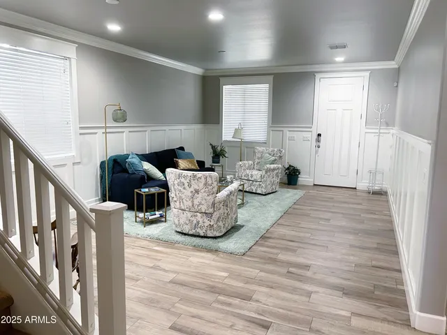a living room with furniture and a potted plant