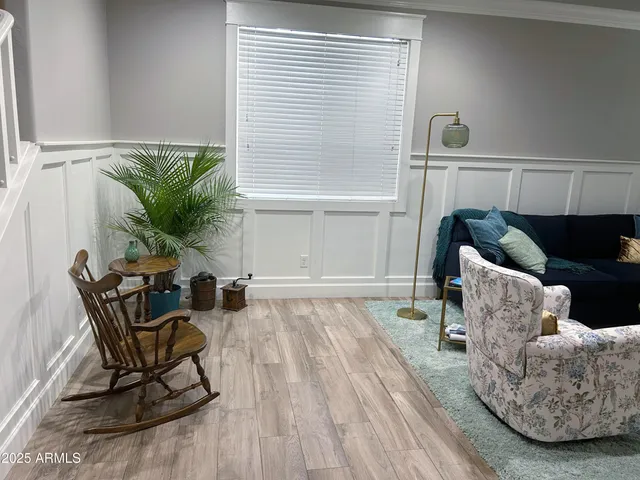 a kitchen with stainless steel appliances granite countertop a refrigerator a sink dishwasher a stove and white cabinets with wooden floor