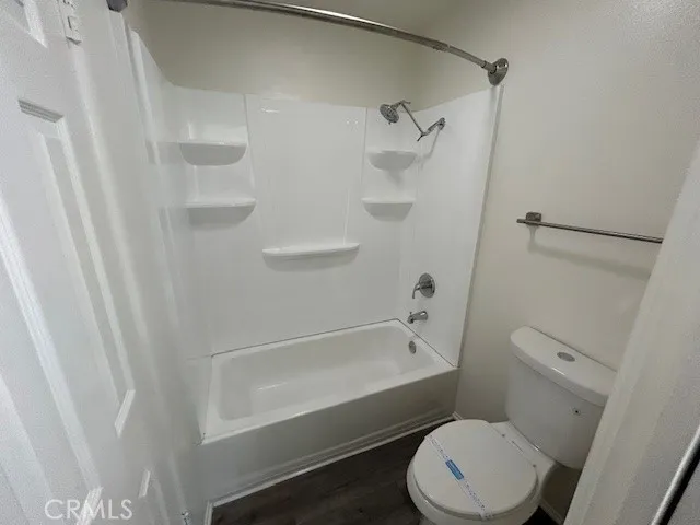 a bathroom with a toilet and a bathtub