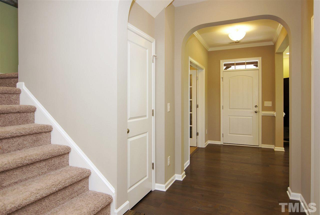 826 Wickham Ridge Road, Unit 6 Apex, NC 27539 - Photo 2 of 25 a view of a hallway with wooden floor and staircase
