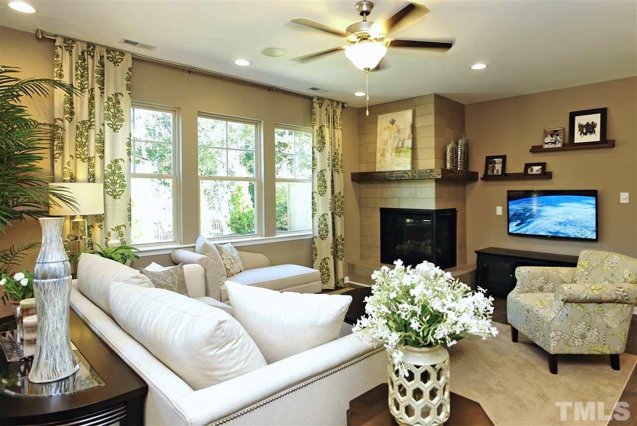 826 Wickham Ridge Road, Unit 6 Apex, NC 27539 - Photo 11 of 25 a living room with furniture flower pot and a fireplace