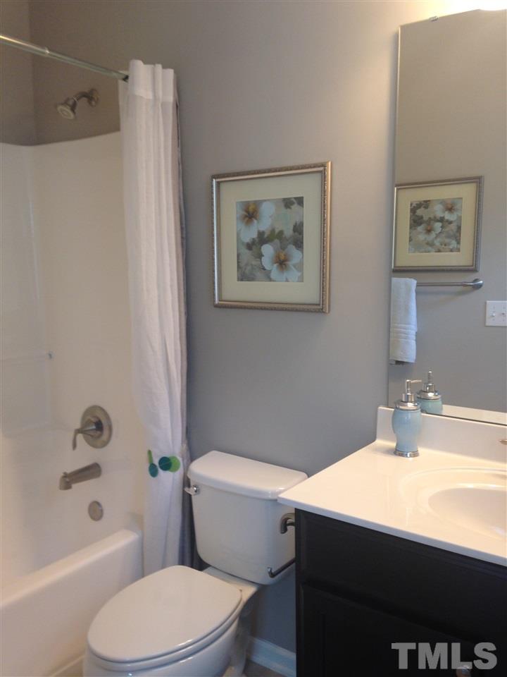 826 Wickham Ridge Road, Unit 6 Apex, NC 27539 - Photo 14 of 25 a bathroom with a sink a toilet and shower