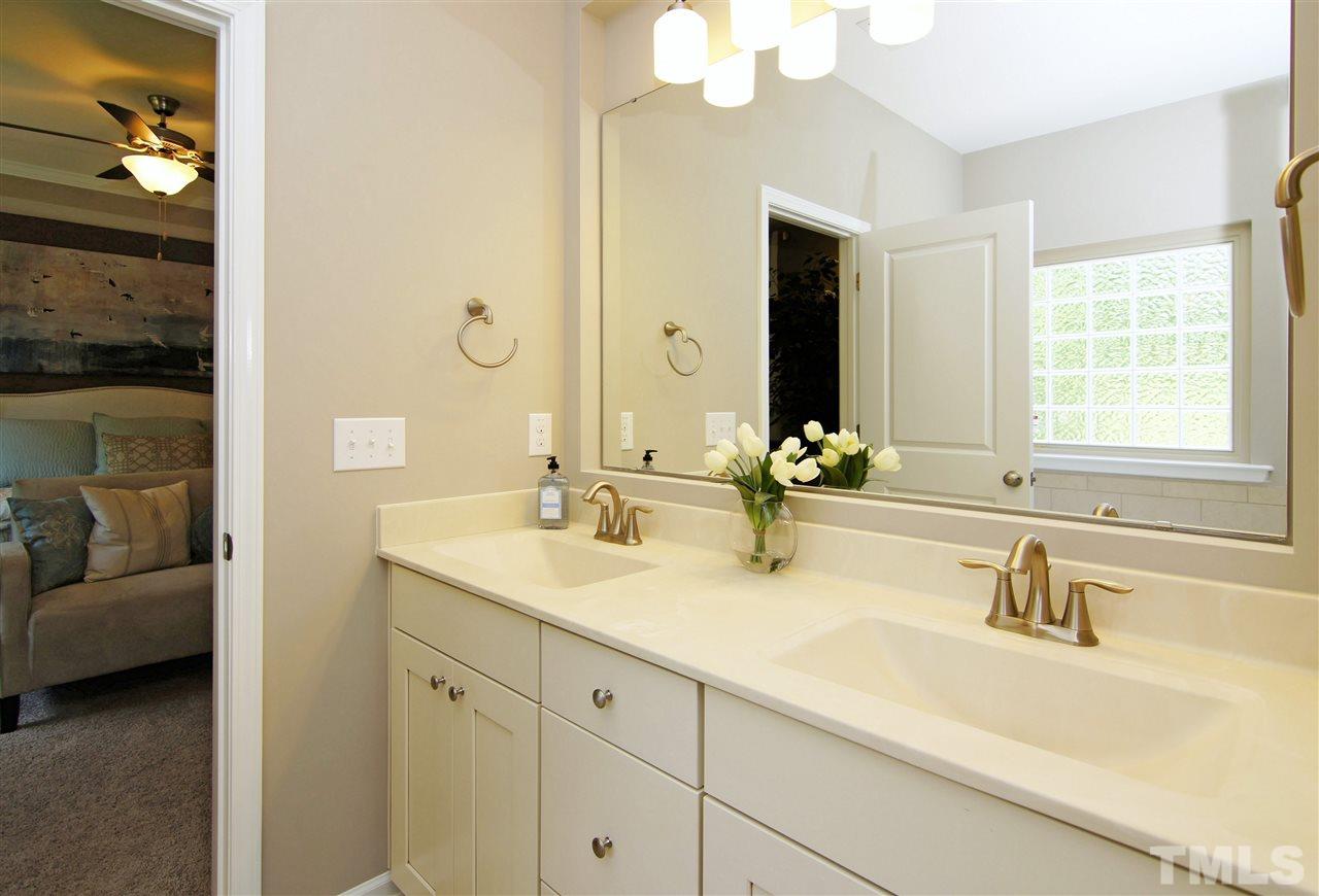 826 Wickham Ridge Road, Unit 6 Apex, NC 27539 - Photo 17 of 25 a bathroom with a sink double vanity granite and a mirror