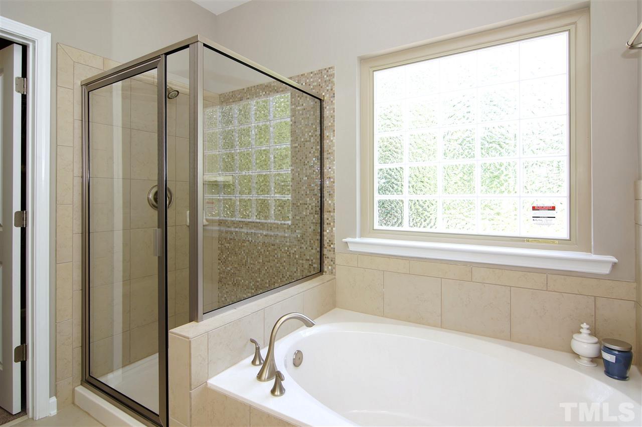 826 Wickham Ridge Road, Unit 6 Apex, NC 27539 - Photo 18 of 25 a bathroom with a bathtub and shower