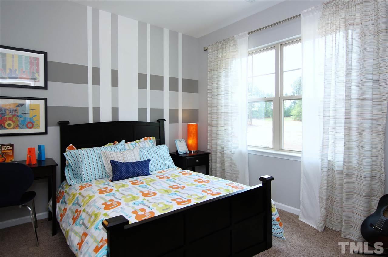 826 Wickham Ridge Road, Unit 6 Apex, NC 27539 - Photo 19 of 25 a bedroom with a bed and a window