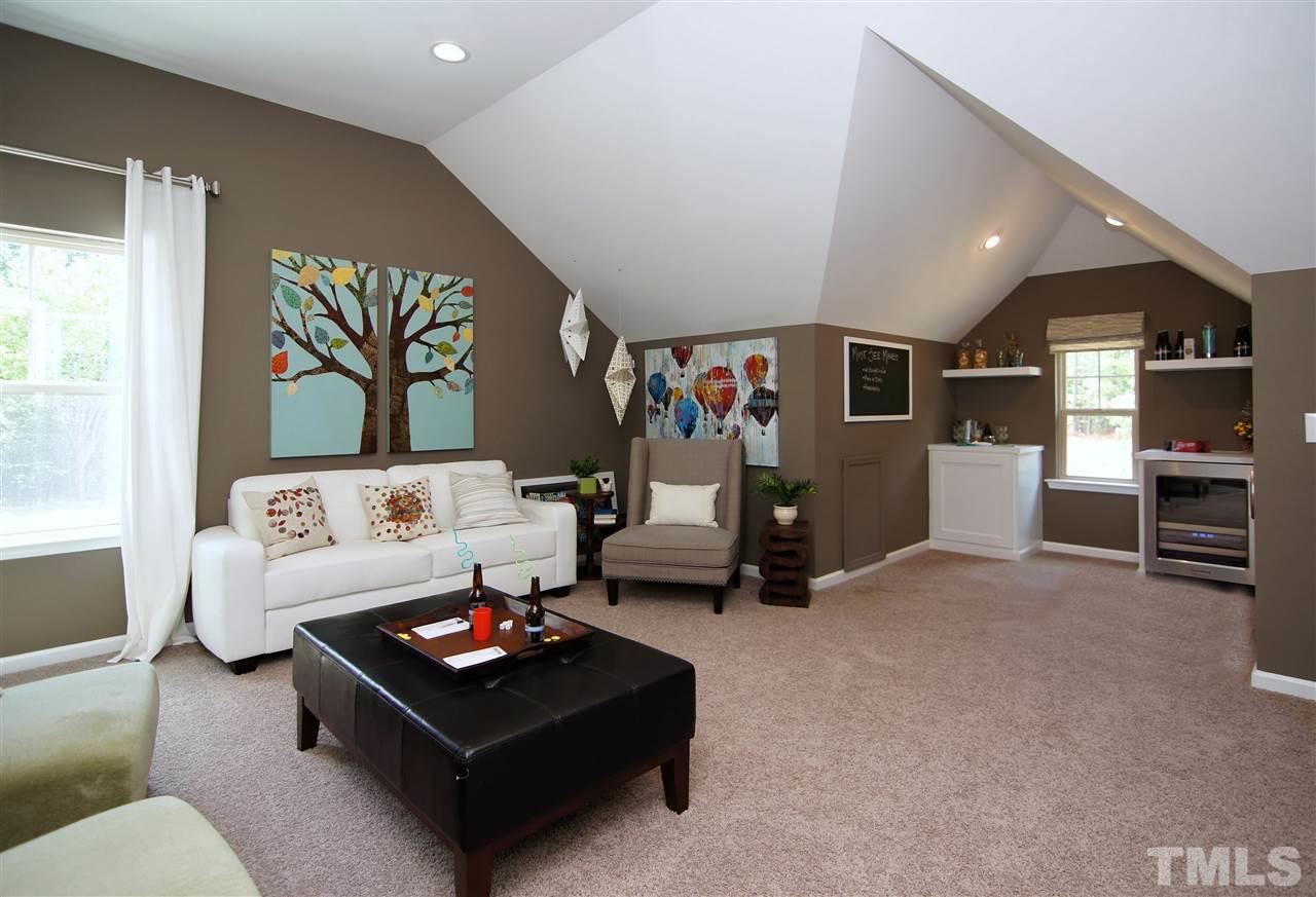 826 Wickham Ridge Road, Unit 6 Apex, NC 27539 - Photo 23 of 25 a living room with furniture and kitchen view